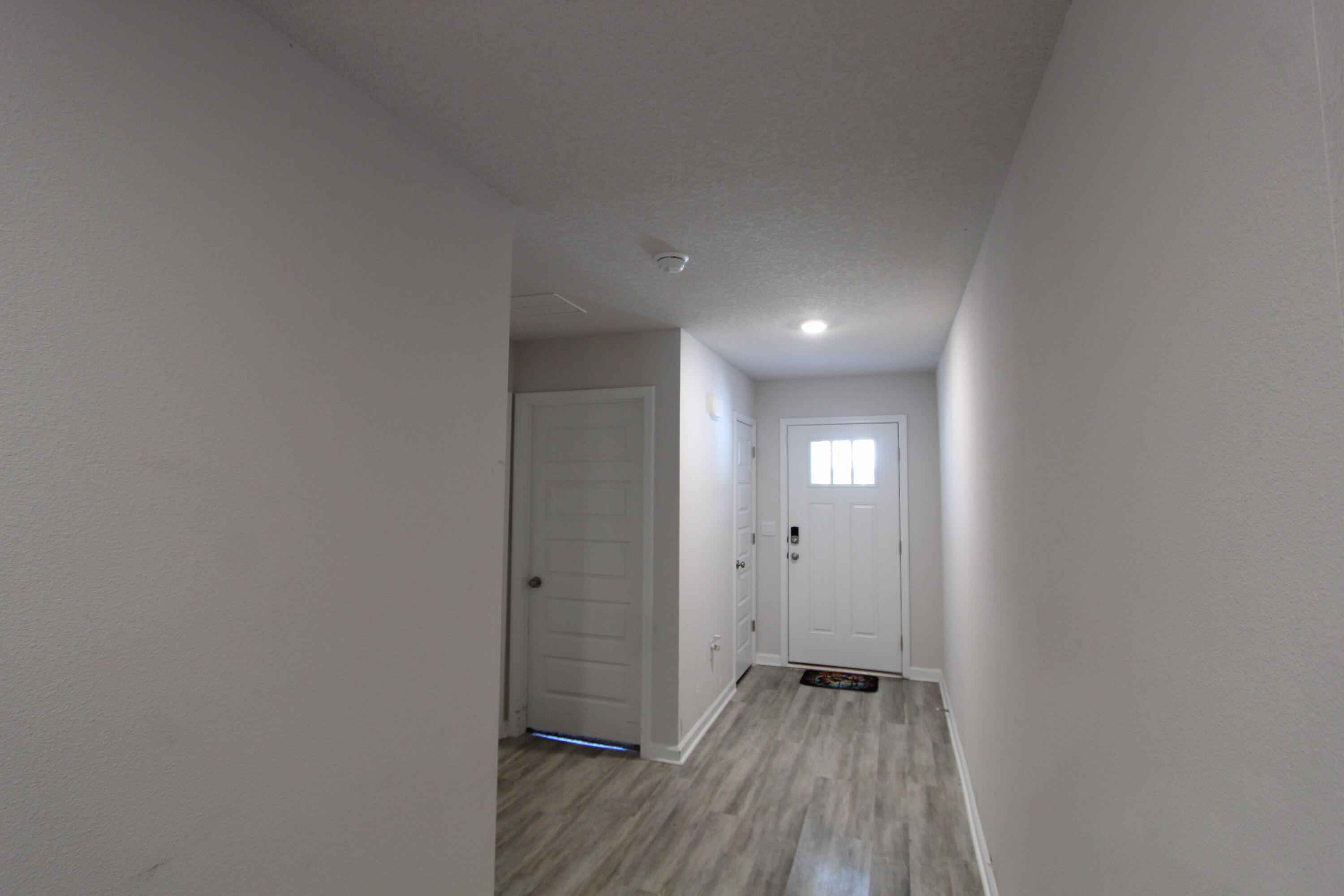 5372 Wyndell Circle Crestview, FL 32539 - Photo 14 of 36 a view of a hallway with wooden floor