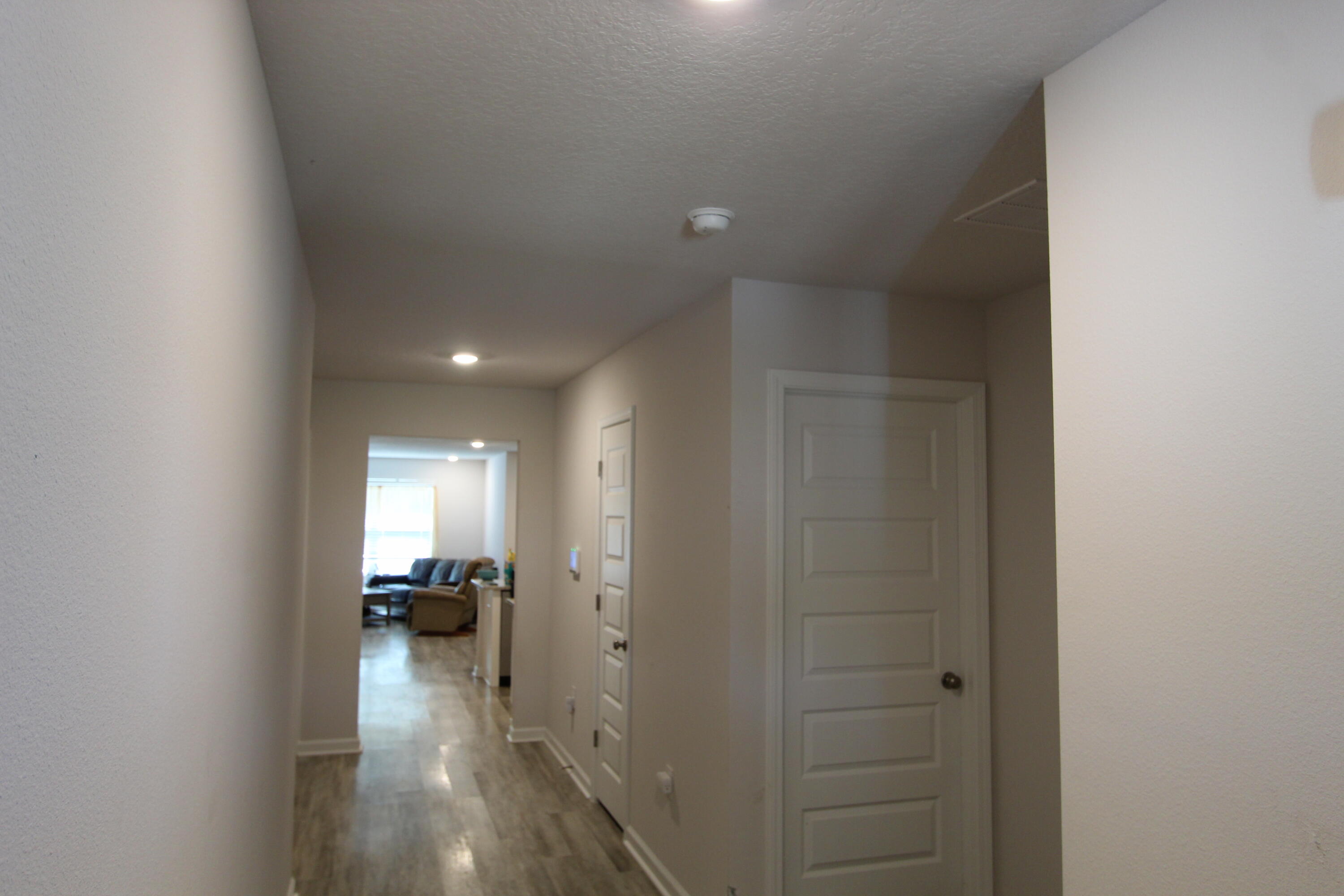5372 Wyndell Circle Crestview, FL 32539 - Photo 15 of 36 a view of a hallway with a livingroom and a bathroom with sink