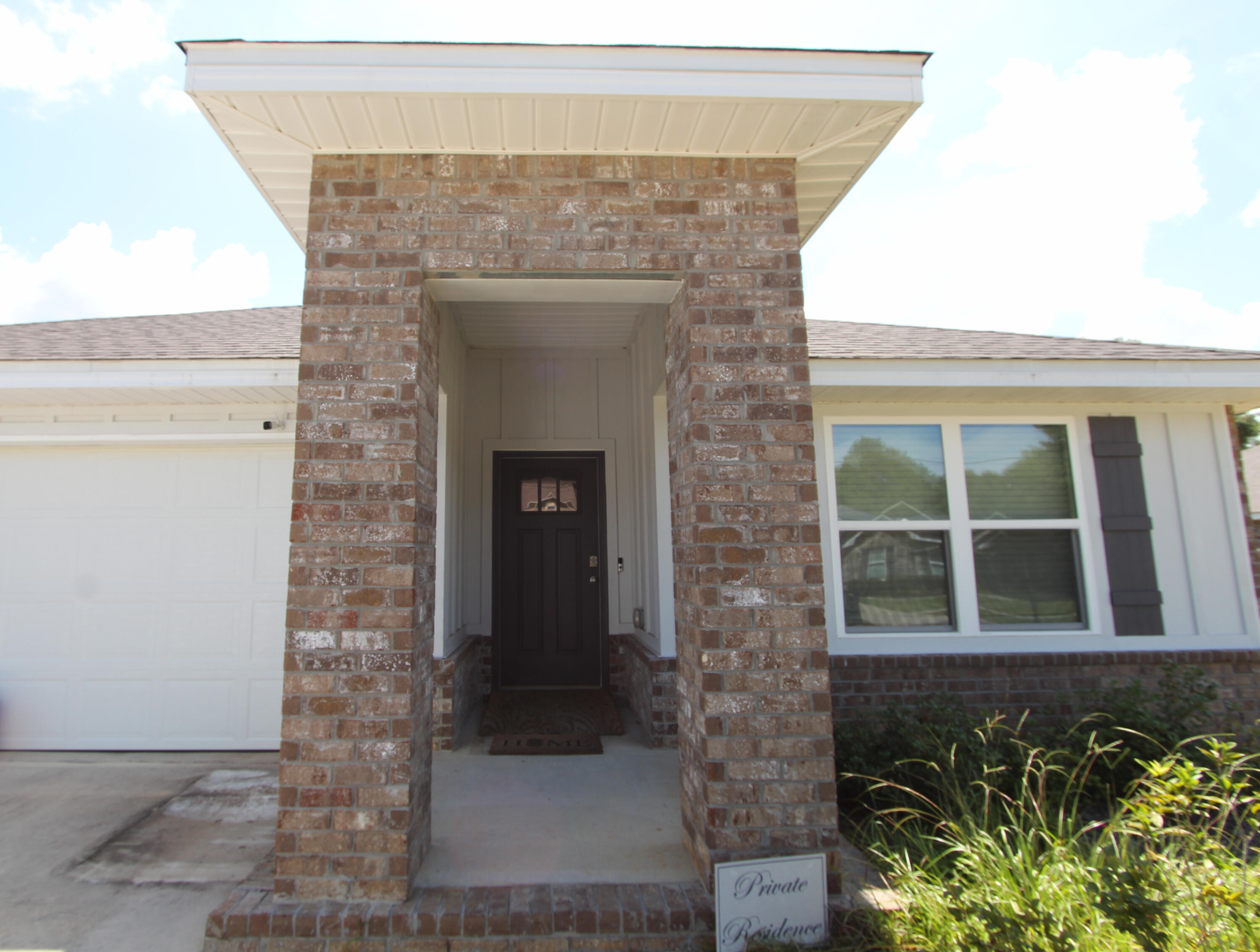 5372 Wyndell Circle Crestview, FL 32539 - Photo 2 of 36 a front view of a house with glass windows