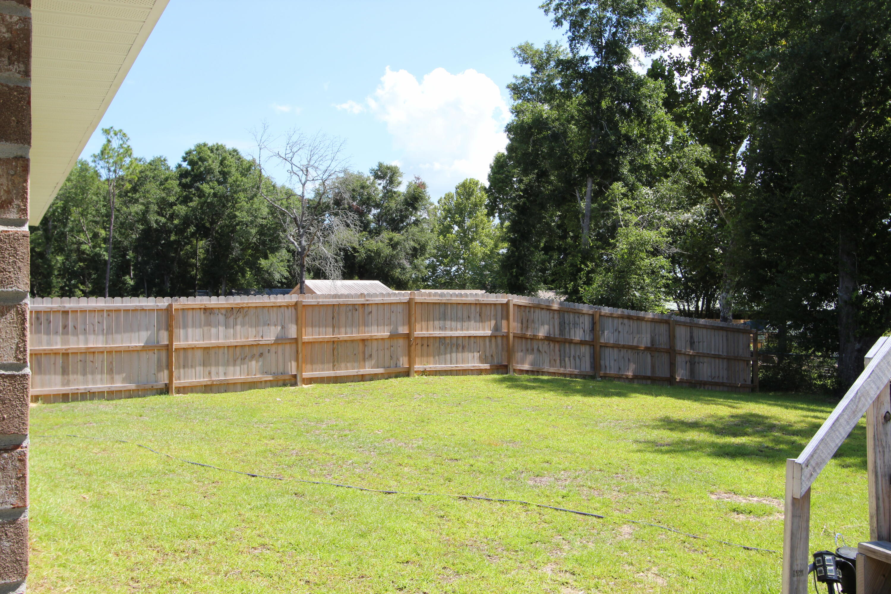 5372 Wyndell Circle Crestview, FL 32539 - Photo 7 of 36 a view of yard with swimming pool and trees in the background