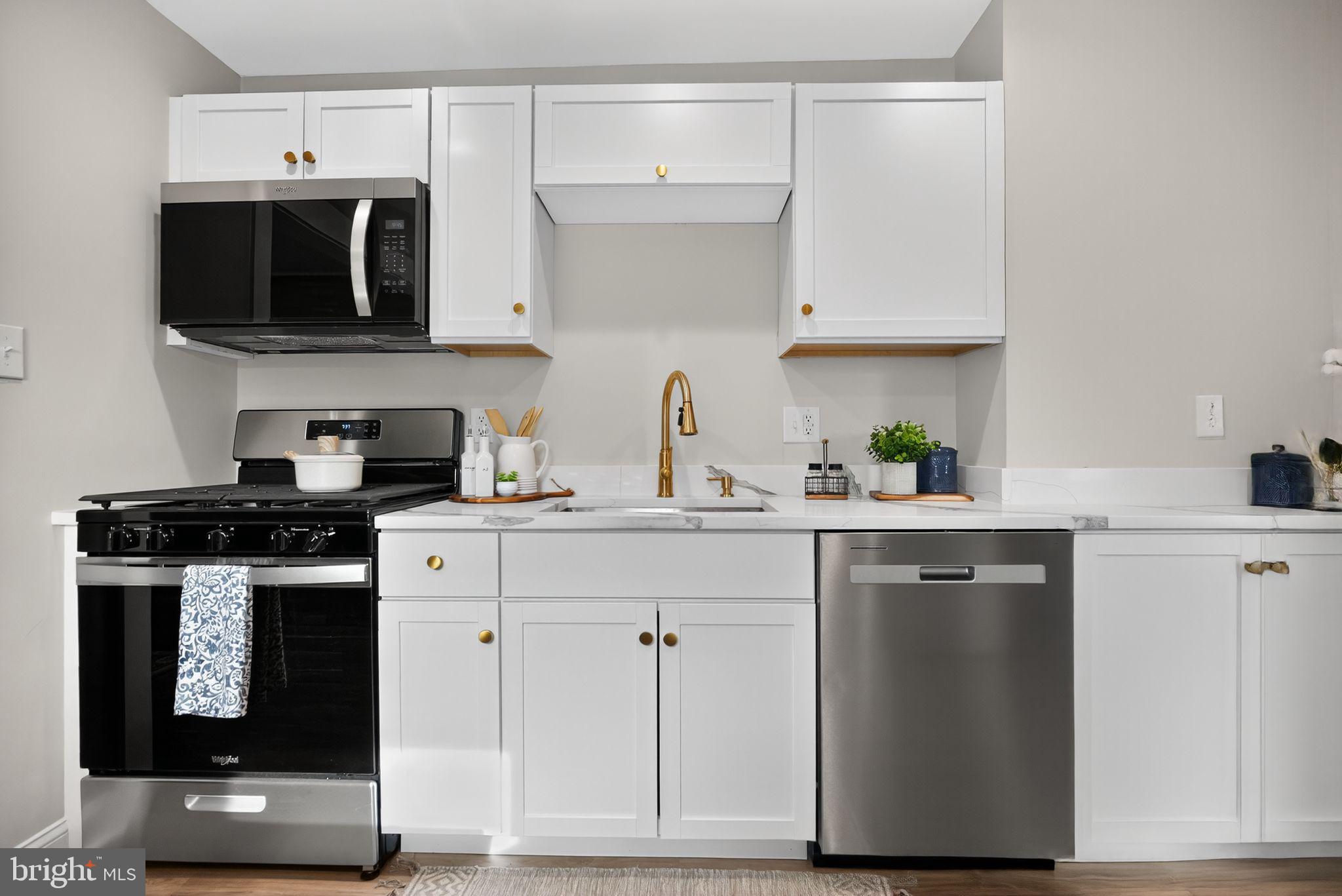 109 State Avenue Lindenwold, NJ 08021 - Photo 11 of 30 a kitchen with stainless steel appliances granite countertop a sink and a stove