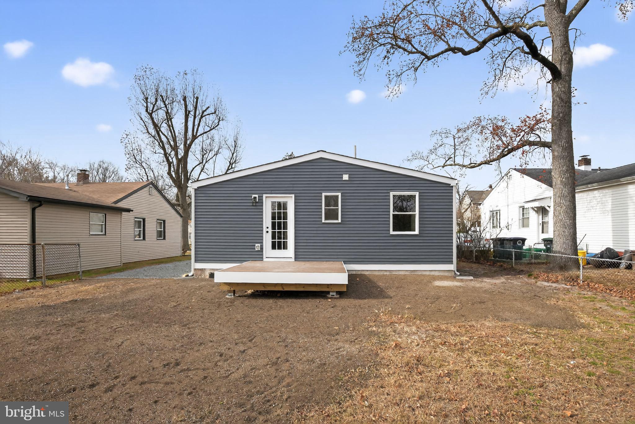 109 State Avenue Lindenwold, NJ 08021 - Photo 28 of 30 a backyard of a house with table and chairs under an umbrella
