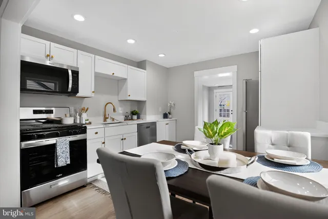 a kitchen with stainless steel appliances granite countertop a sink and a stove