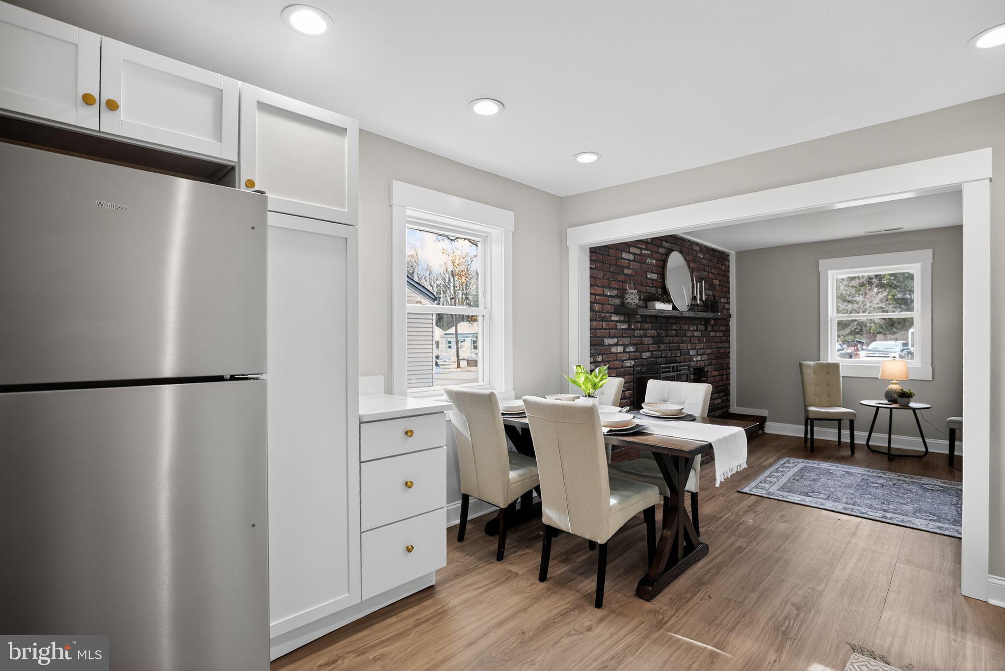 109 State Avenue Lindenwold, NJ 08021 - Photo 8 of 30 a kitchen with a refrigerator a table chairs and a refrigerator