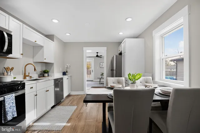 a kitchen with granite countertop a sink stove and cabinets