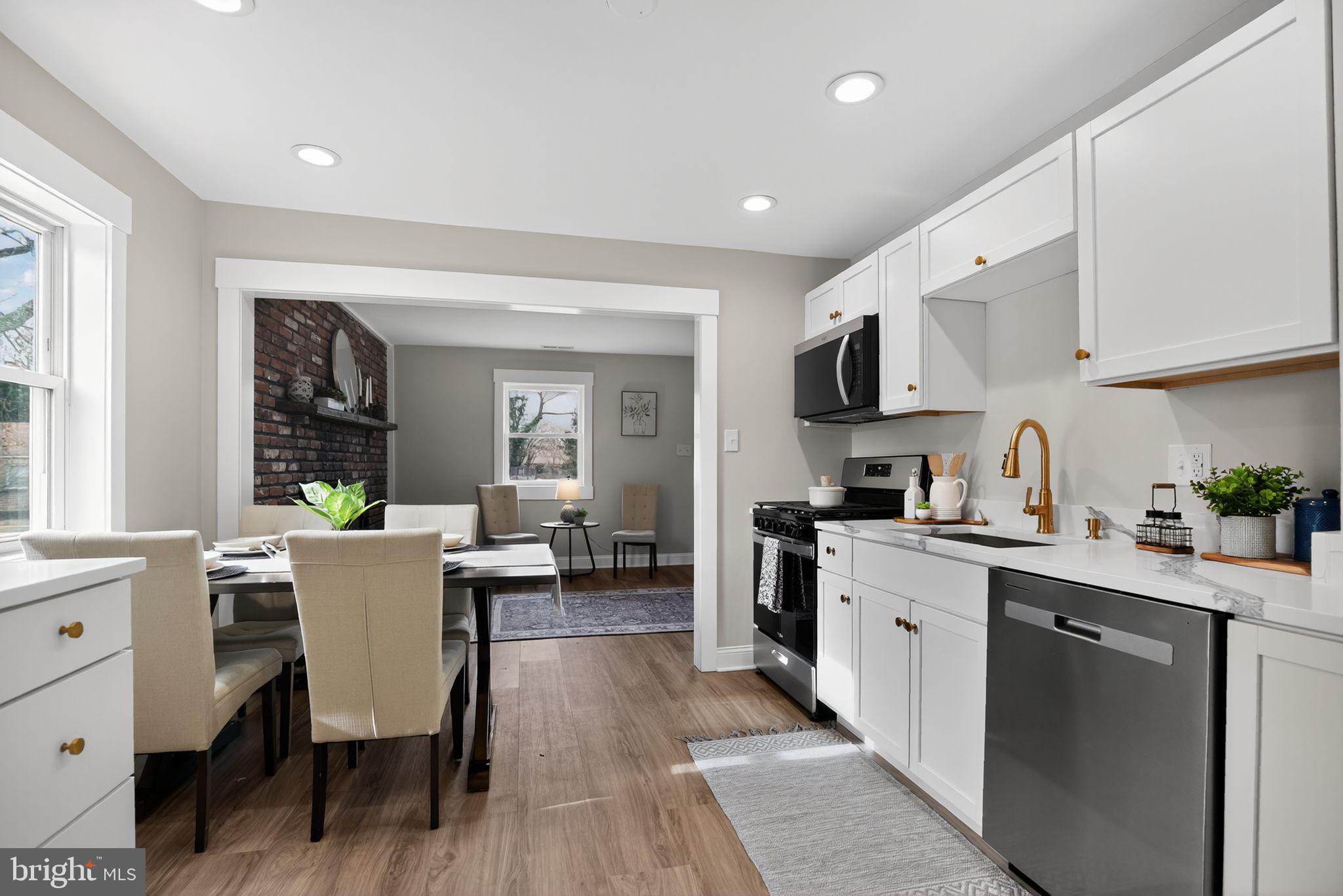 109 State Avenue Lindenwold, NJ 08021 - Photo 10 of 30 a kitchen with a table chairs microwave and cabinets
