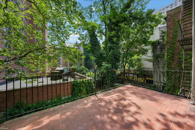 a kitchen with stainless steel appliances granite countertop a sink dishwasher stove and cabinets with wooden floor