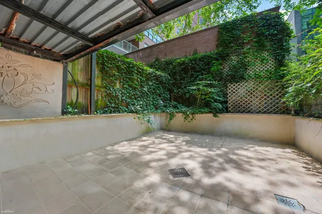 a view of a patio with table and chairs and potted plants