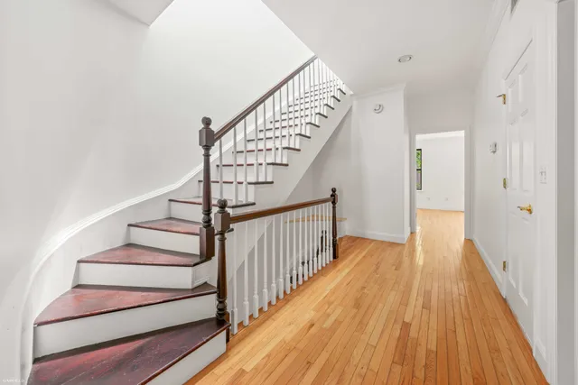 a spacious bedroom with a bed and a potted plant