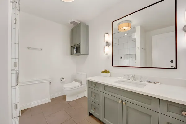a bathroom with a shower a toilet and a sink