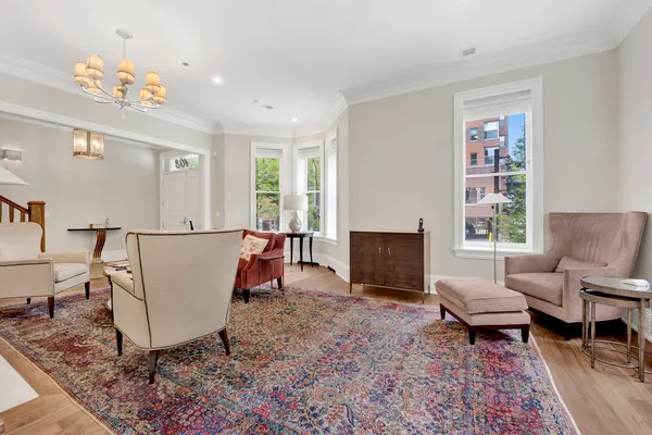 a living room with furniture and a chandelier