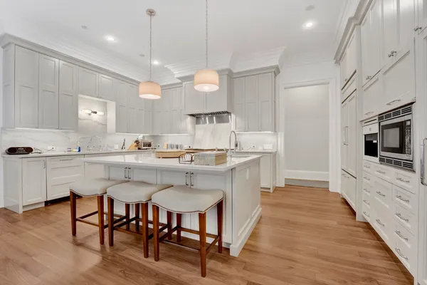 a large kitchen with a table and chairs