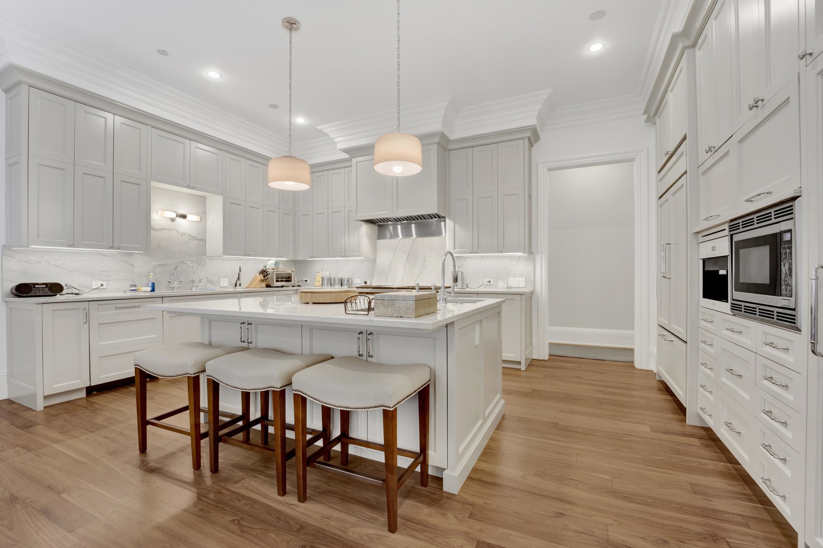 103 West Chestnut Street Chicago, IL 60610 - Photo 10 of 51 a kitchen with kitchen island granite countertop a table chairs sink and cabinets