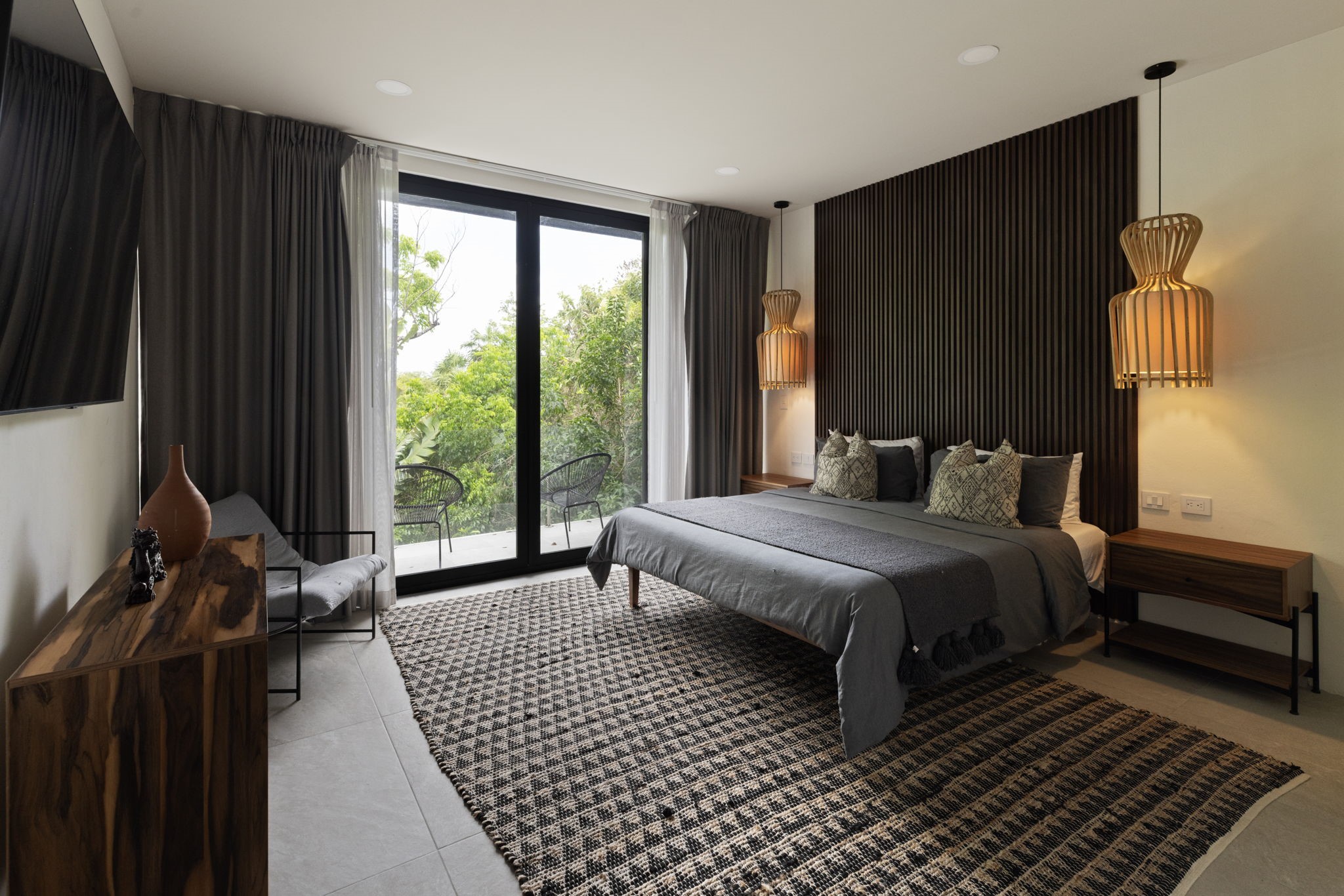 6 Country Club, Unit 4 Nome, TX 77629 - Photo 26 of 45 This stunning secondary bedroom mirrors the luxurious design of the primary suite, serving as a private eco-luxury sanctuary with a direct connection to Cozumel's lush environment.