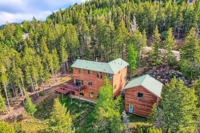 an aerial view of a house with a yard basket ball court and outdoor seating