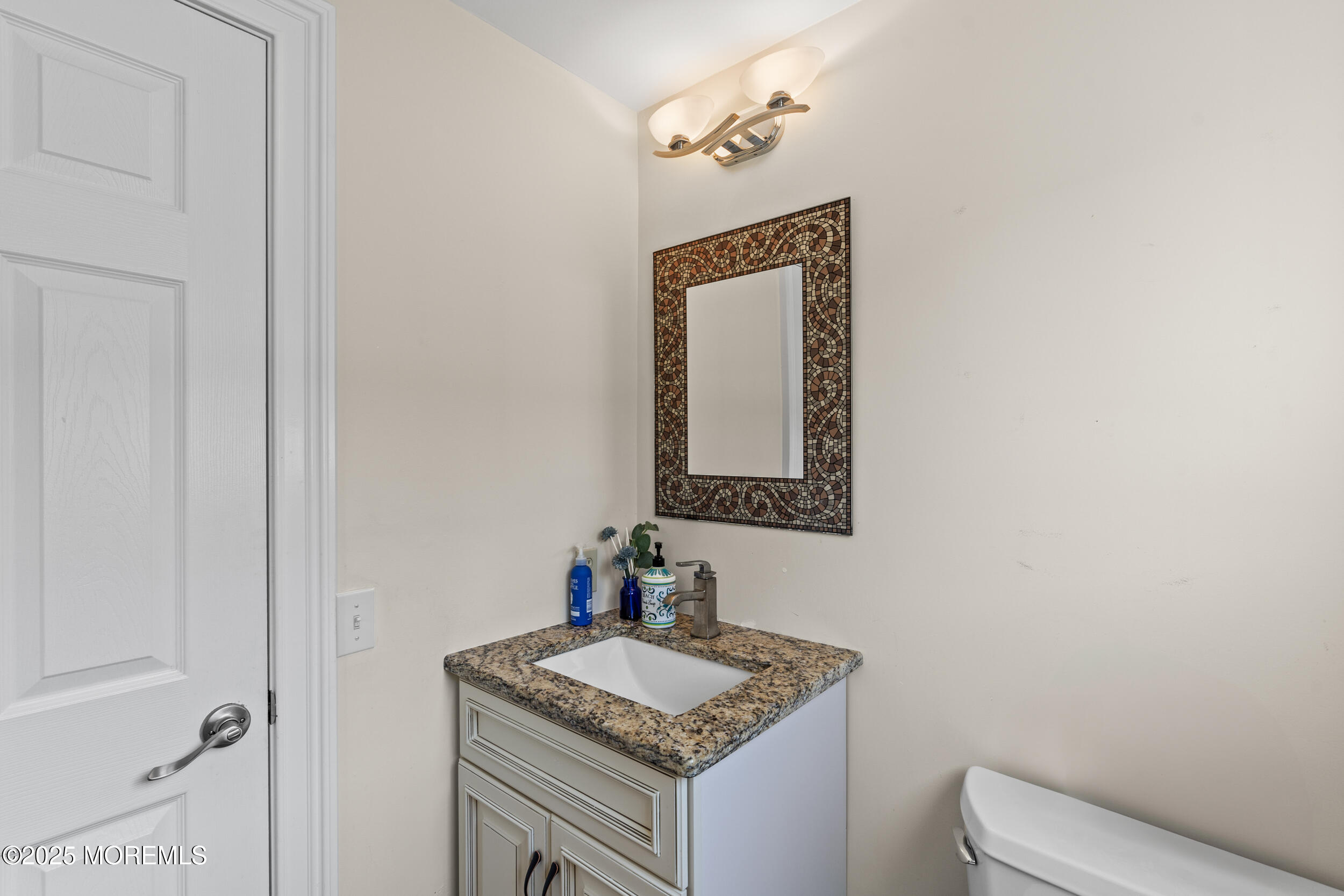 450 Ocean Boulevard, Unit 8 Long Branch, NJ 07740 - Photo 12 of 33 a bathroom with a granite countertop sink and a mirror