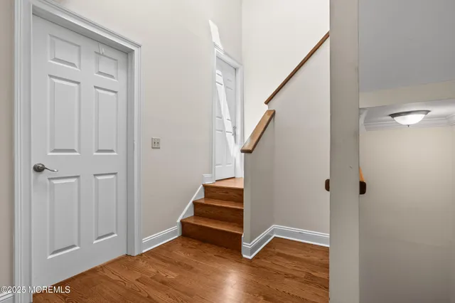 a view of entryway with stairs and wooden floor