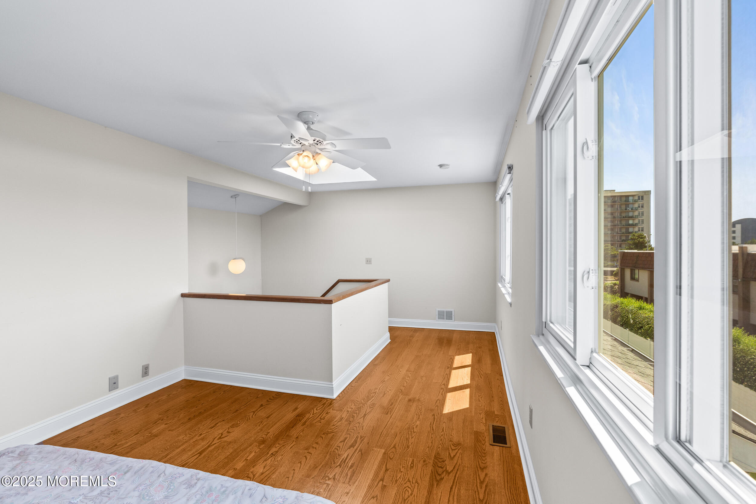 450 Ocean Boulevard, Unit 8 Long Branch, NJ 07740 - Photo 26 of 33 wooden floor in an empty room with a window