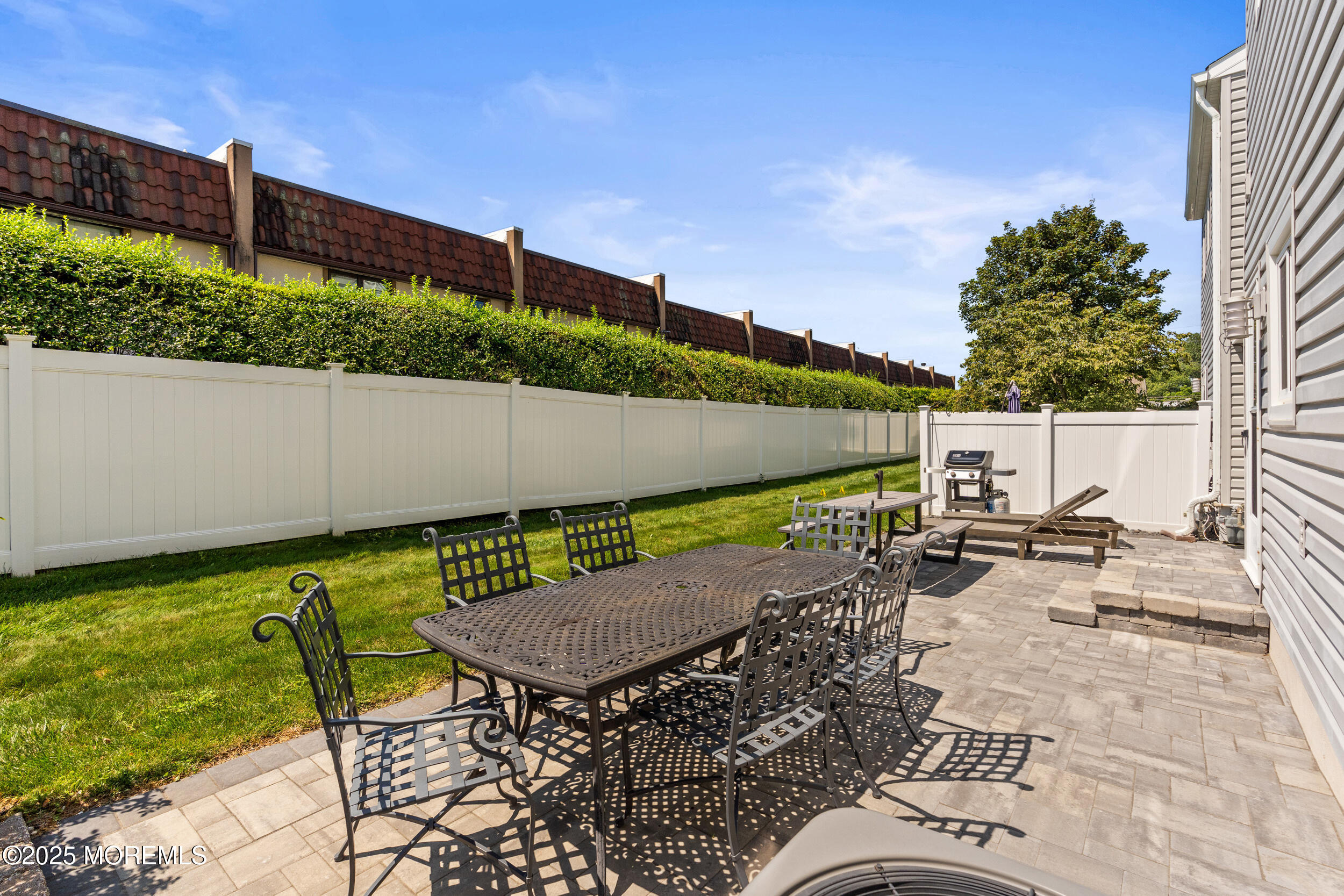450 Ocean Boulevard, Unit 8 Long Branch, NJ 07740 - Photo 27 of 33 a view of backyard with seating space and trees in the background