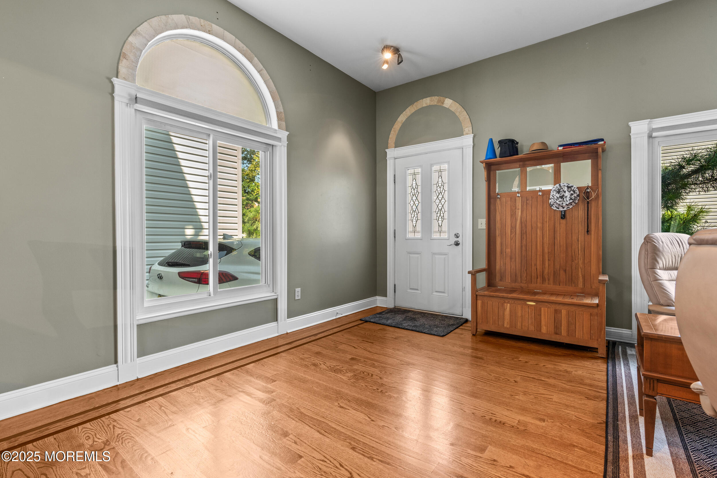 450 Ocean Boulevard, Unit 8 Long Branch, NJ 07740 - Photo 4 of 33 a view of an empty room with wooden floor and a window