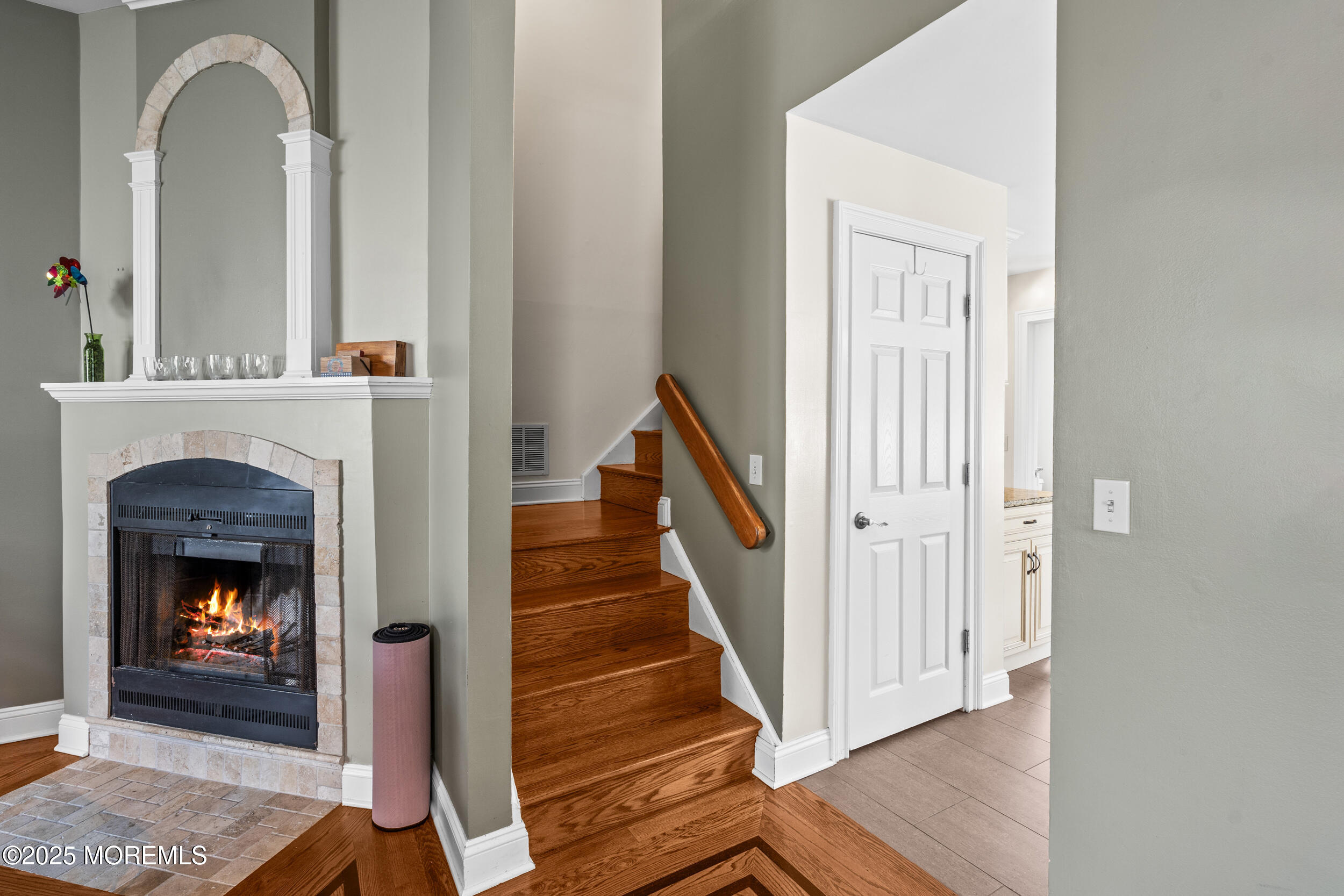 450 Ocean Boulevard, Unit 8 Long Branch, NJ 07740 - Photo 8 of 33 a view of a livingroom with wooden floor and a fireplace