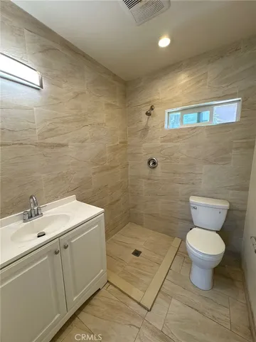a bathroom with a sink toilet a mirror and shower