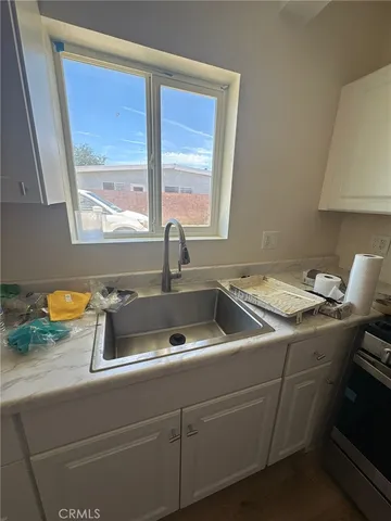 a stove top oven sitting inside of a kitchen