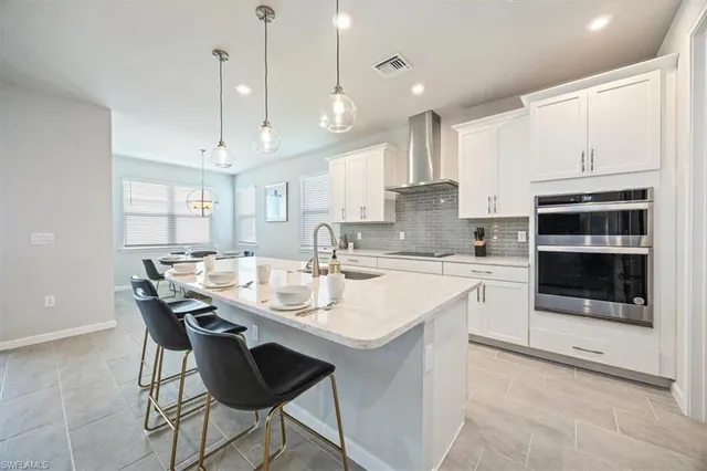 a kitchen with stainless steel appliances kitchen island granite countertop a sink and cabinets