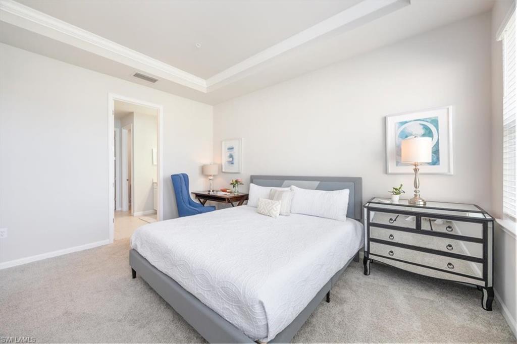 4687 Arboretum Circle, Unit 203 Naples, FL 34112 - Photo 16 of 24 a large white bed in a white room