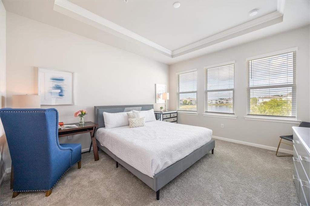 4687 Arboretum Circle, Unit 203 Naples, FL 34112 - Photo 17 of 24 a bedroom with a bed and wooden floor