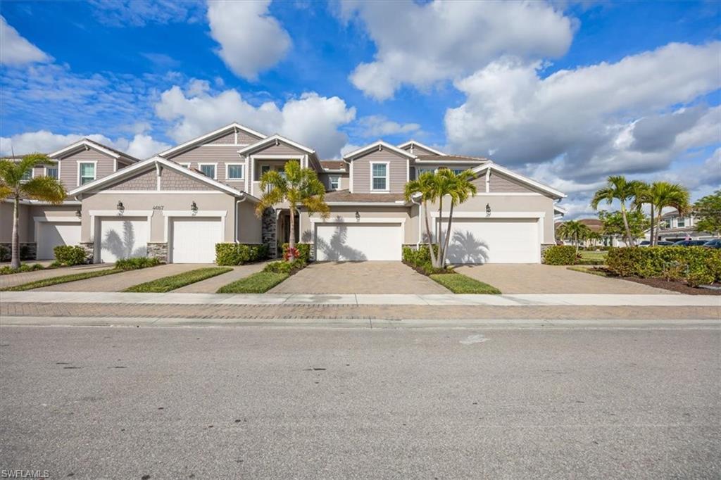 4687 Arboretum Circle, Unit 203 Naples, FL 34112 - Photo 2 of 24 front view of a house with a street