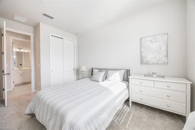 a bedroom with a bed and a night stand