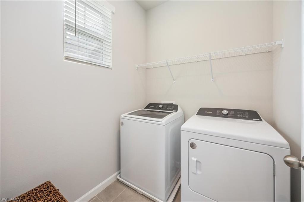4687 Arboretum Circle, Unit 203 Naples, FL 34112 - Photo 22 of 24 a utility room with dryer and washer