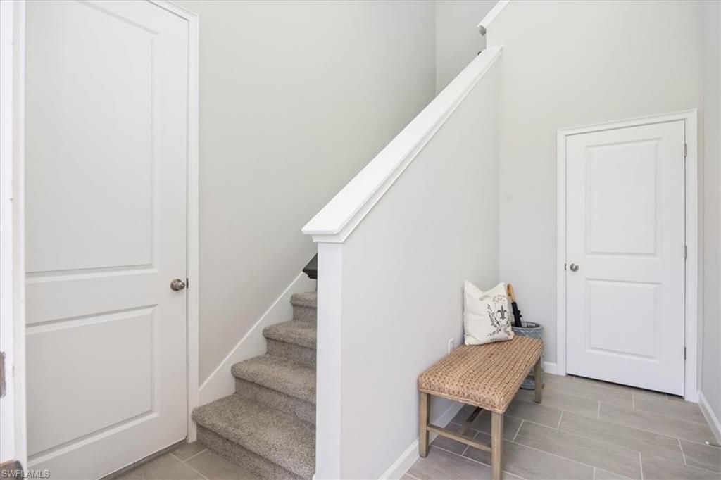 4687 Arboretum Circle, Unit 203 Naples, FL 34112 - Photo 5 of 24 a view of entryway with stairs and furniture