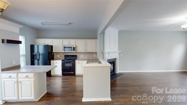 a kitchen with stainless steel appliances a refrigerator sink and cabinets