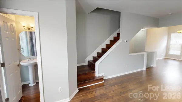 a view of entryway and hall with wooden floor