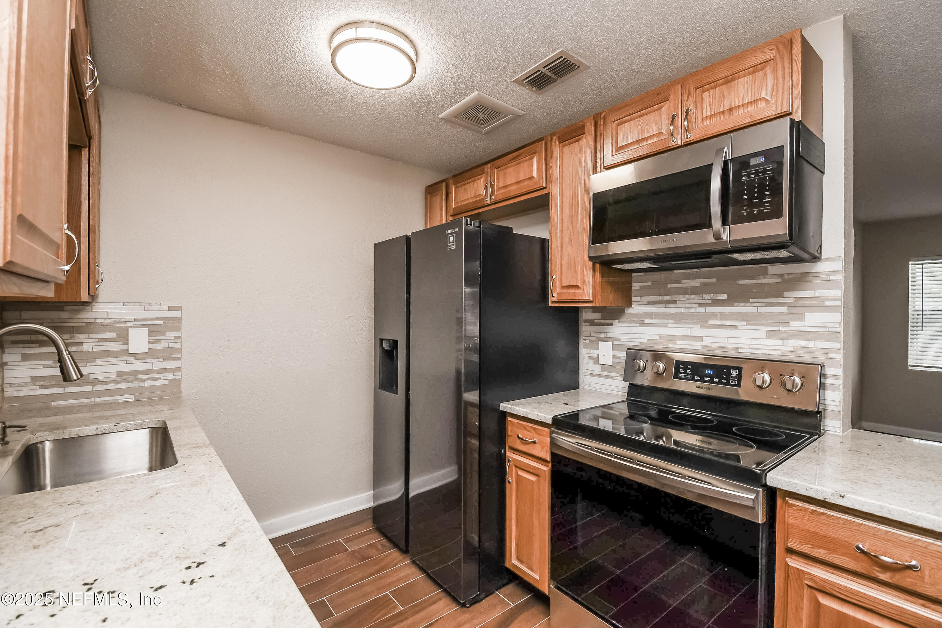 10429 Anders Boulevard Jacksonville, FL 32246 - Photo 5 of 15 a kitchen with a stove and a microwave