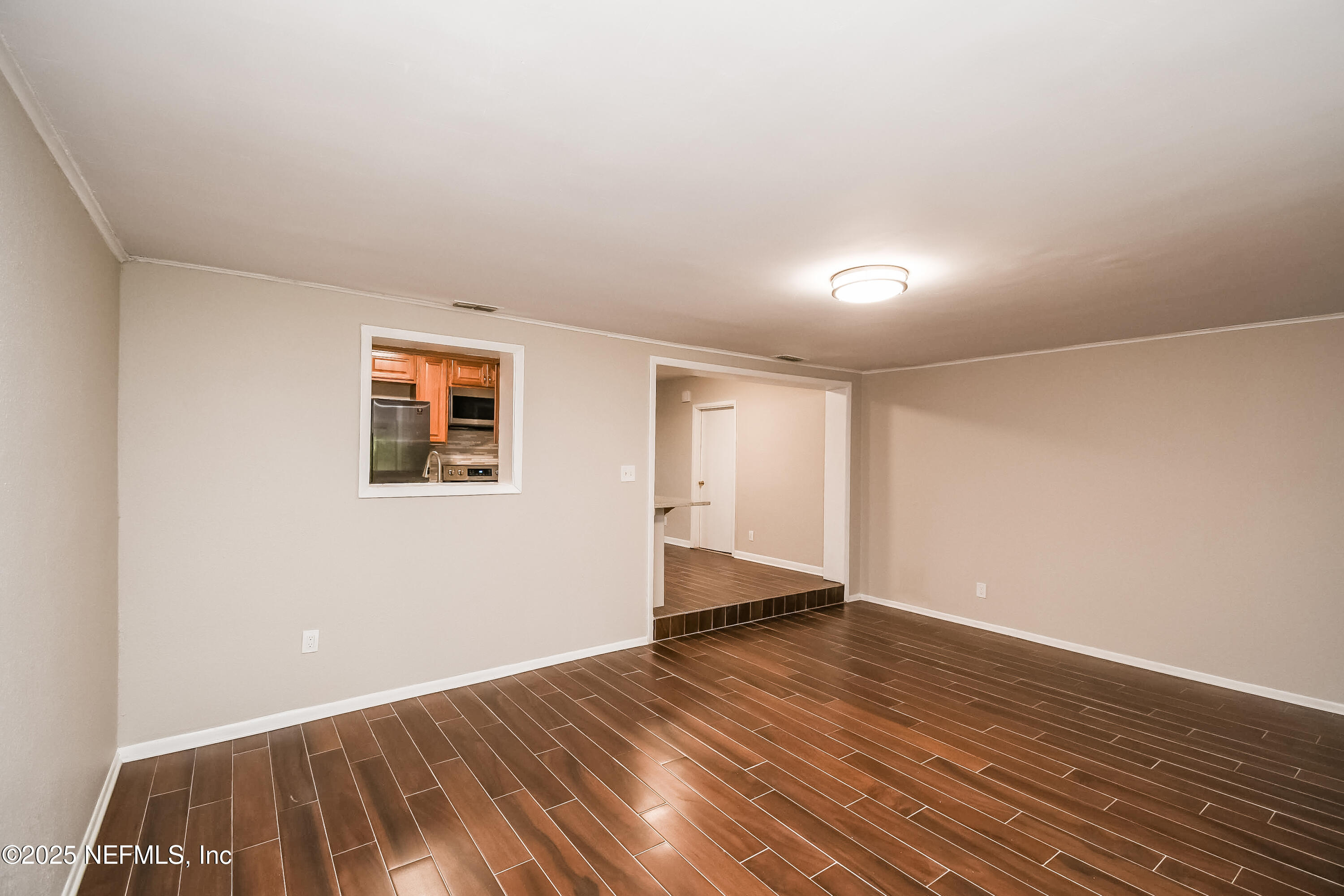 10429 Anders Boulevard Jacksonville, FL 32246 - Photo 7 of 15 a view of an empty room with wooden floor