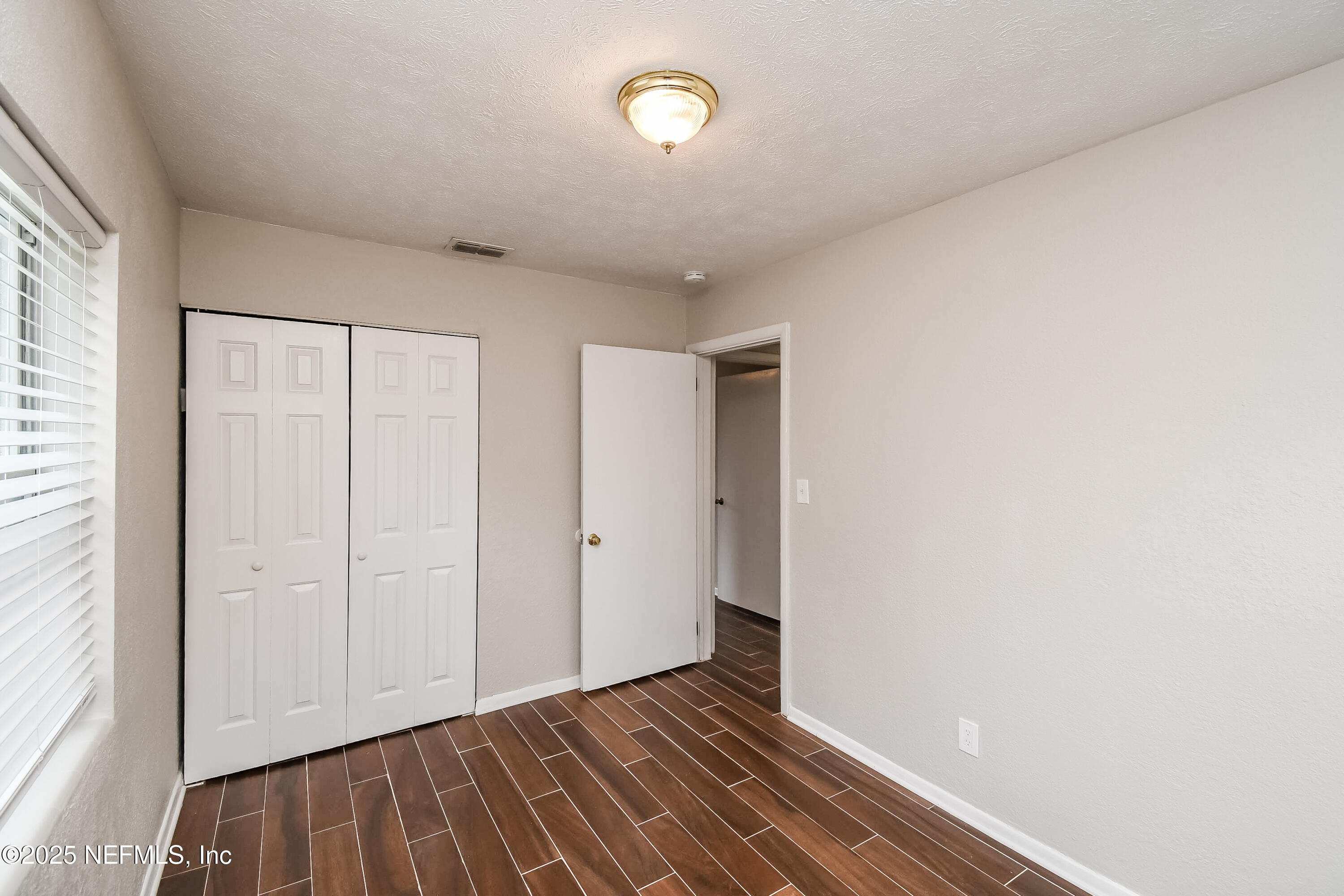 10429 Anders Boulevard Jacksonville, FL 32246 - Photo 8 of 15 a view of an empty room with wooden floor and a window