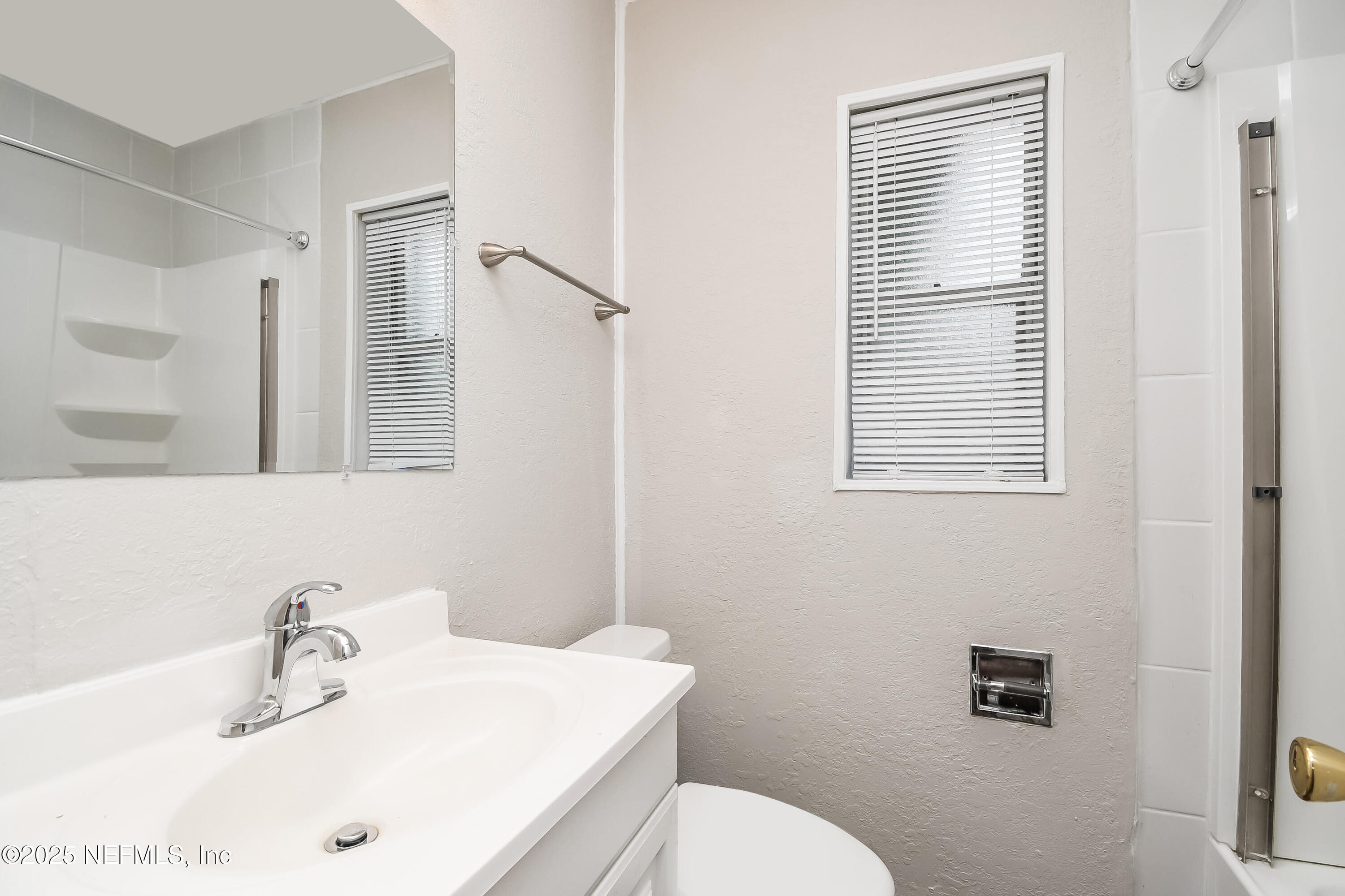 10429 Anders Boulevard Jacksonville, FL 32246 - Photo 9 of 15 a bathroom with a sink a toilet and a mirror