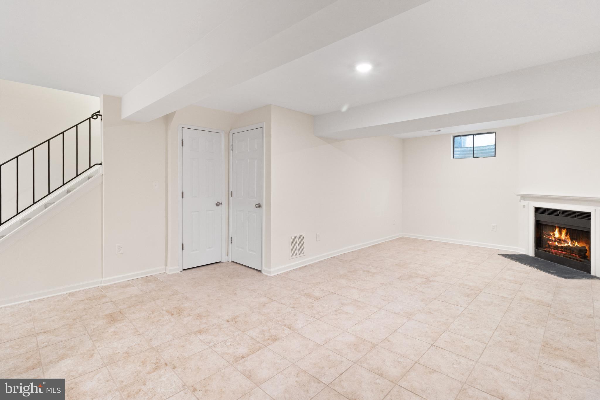 8581 Chester Grove Court Springfield, VA 22153 - Photo 33 of 38 a view of an empty room with a fireplace