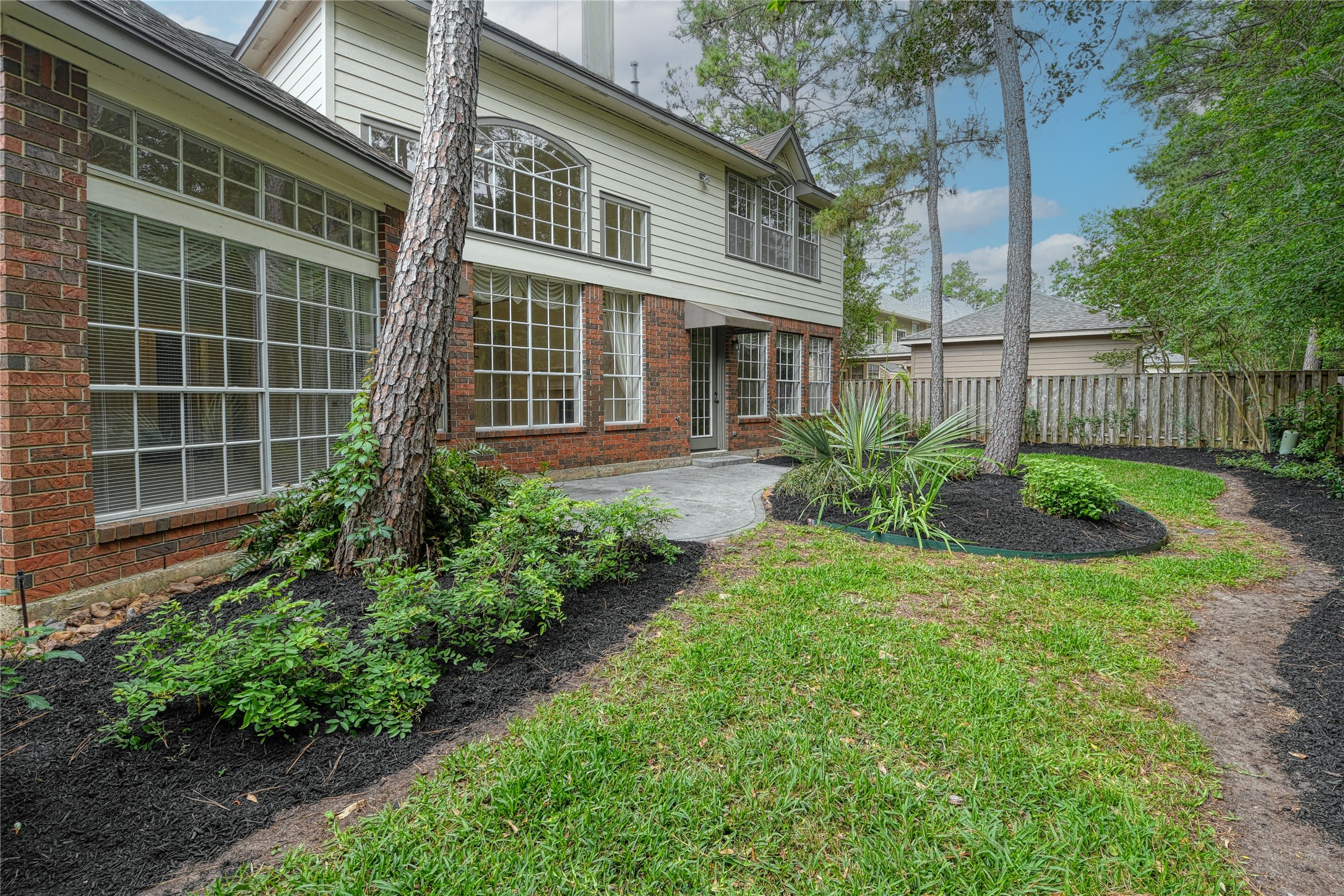 2 Woodmere Place Spring, TX 77381 - Photo 18 of 20 a front view of a house with garden