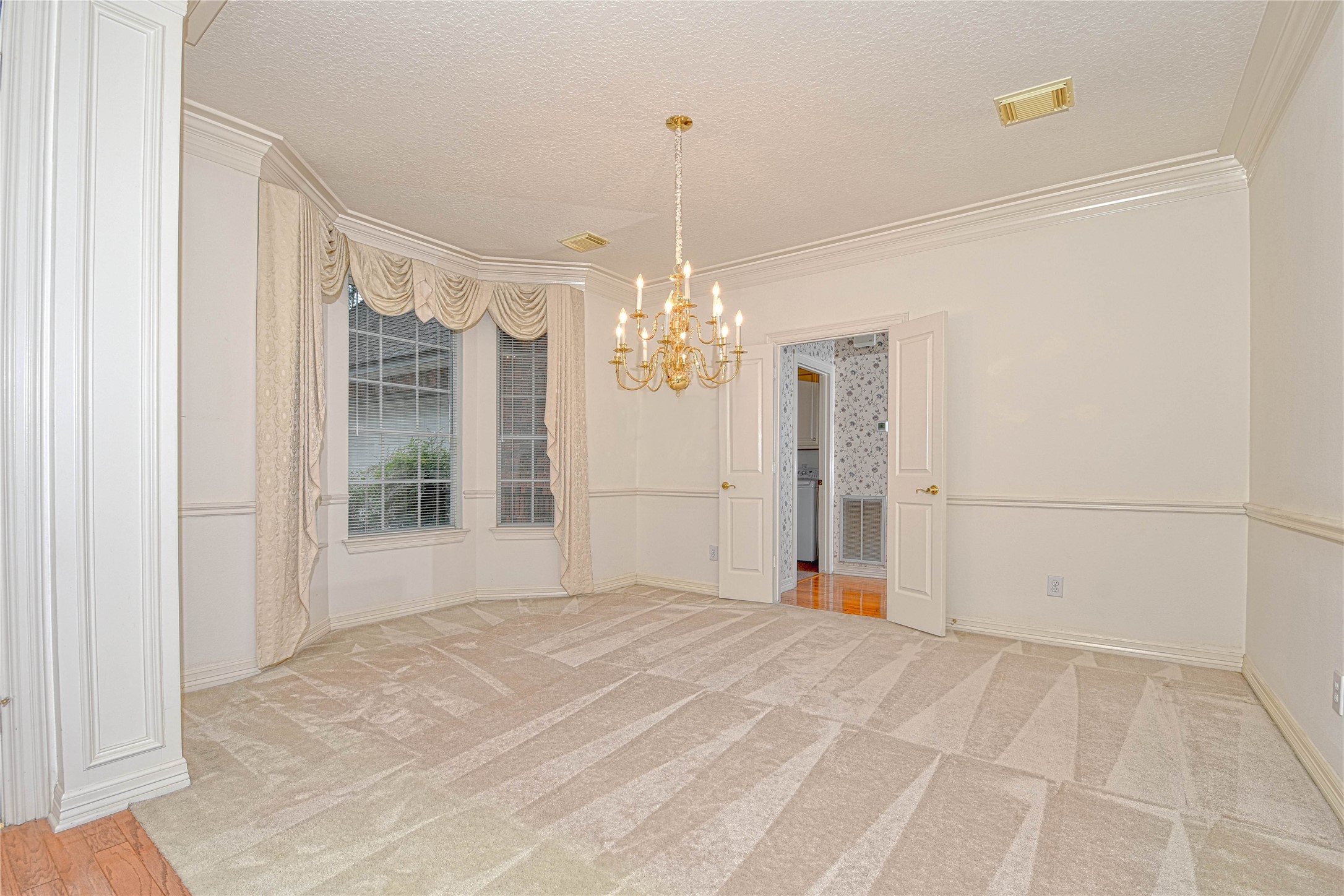 2 Woodmere Place Spring, TX 77381 - Photo 5 of 20 a view of a room with window and chandelier