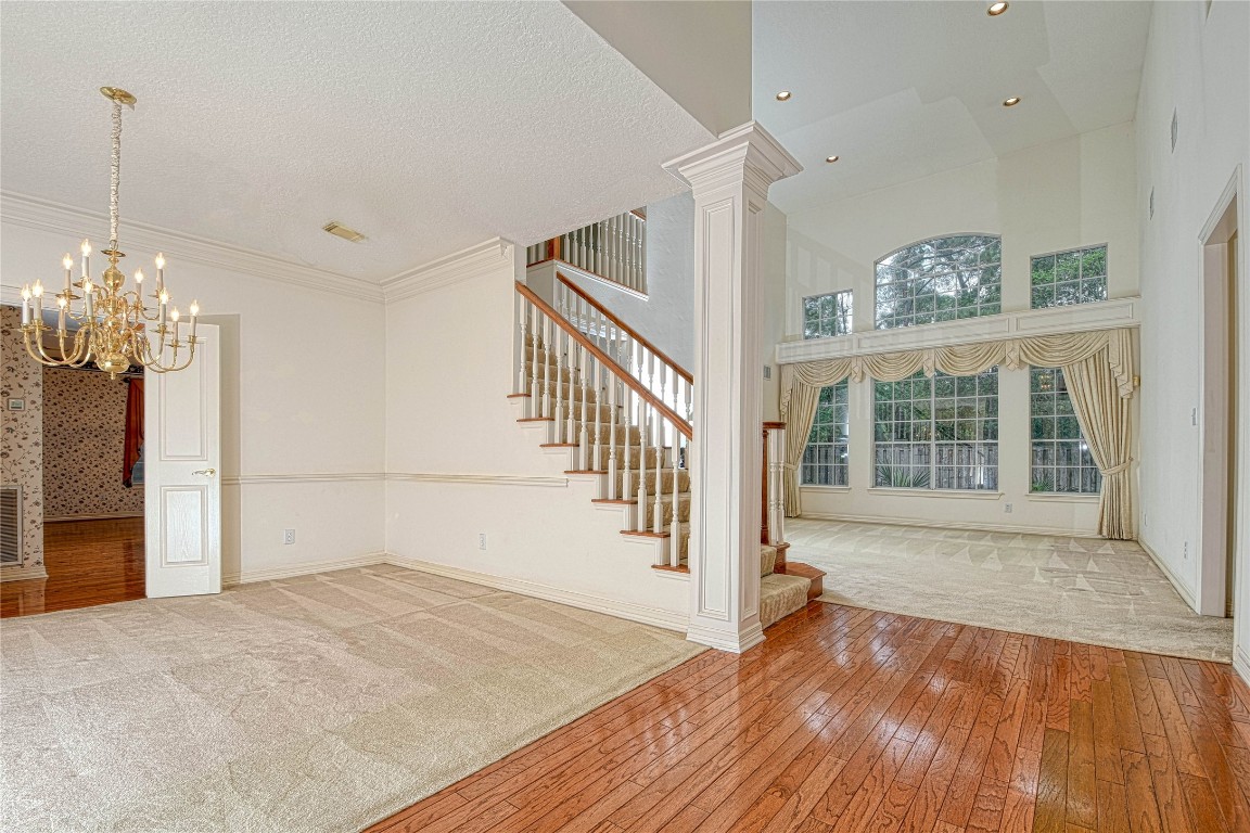 2 Woodmere Place Spring, TX 77381 - Photo 6 of 20 a view of an empty room with wooden floor and a window