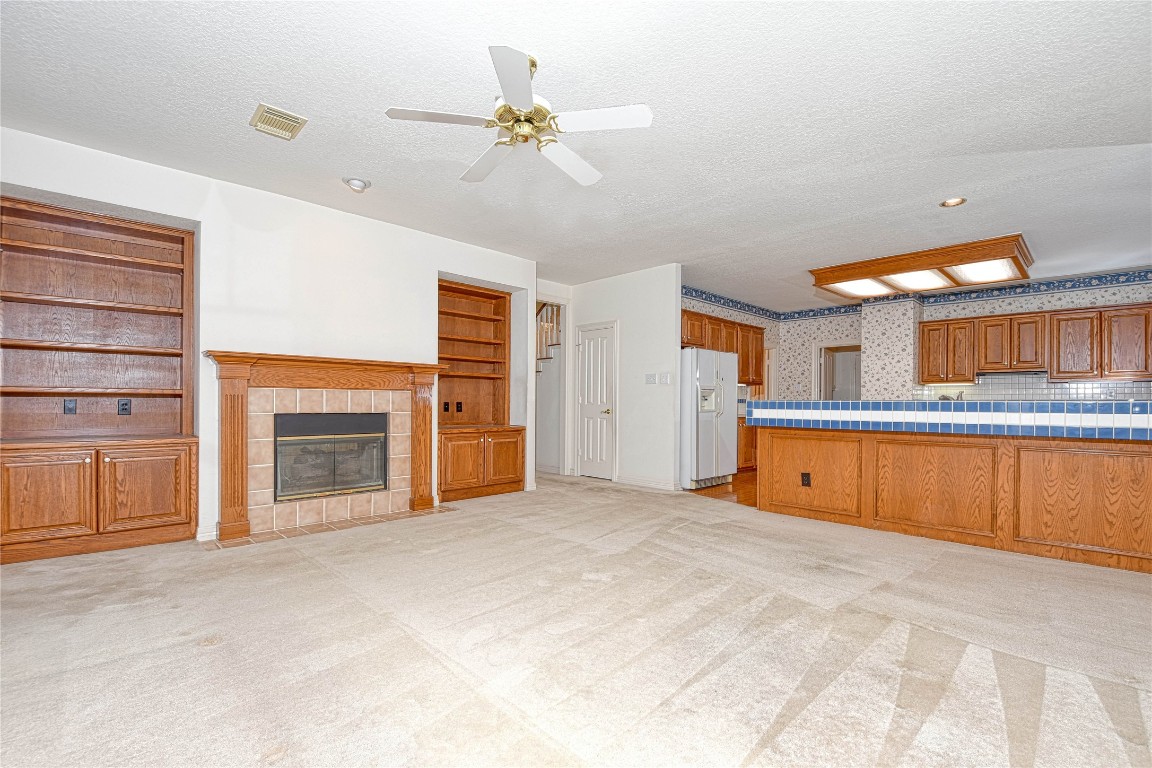 2 Woodmere Place Spring, TX 77381 - Photo 8 of 20 a view of an empty room with a fireplace and a window