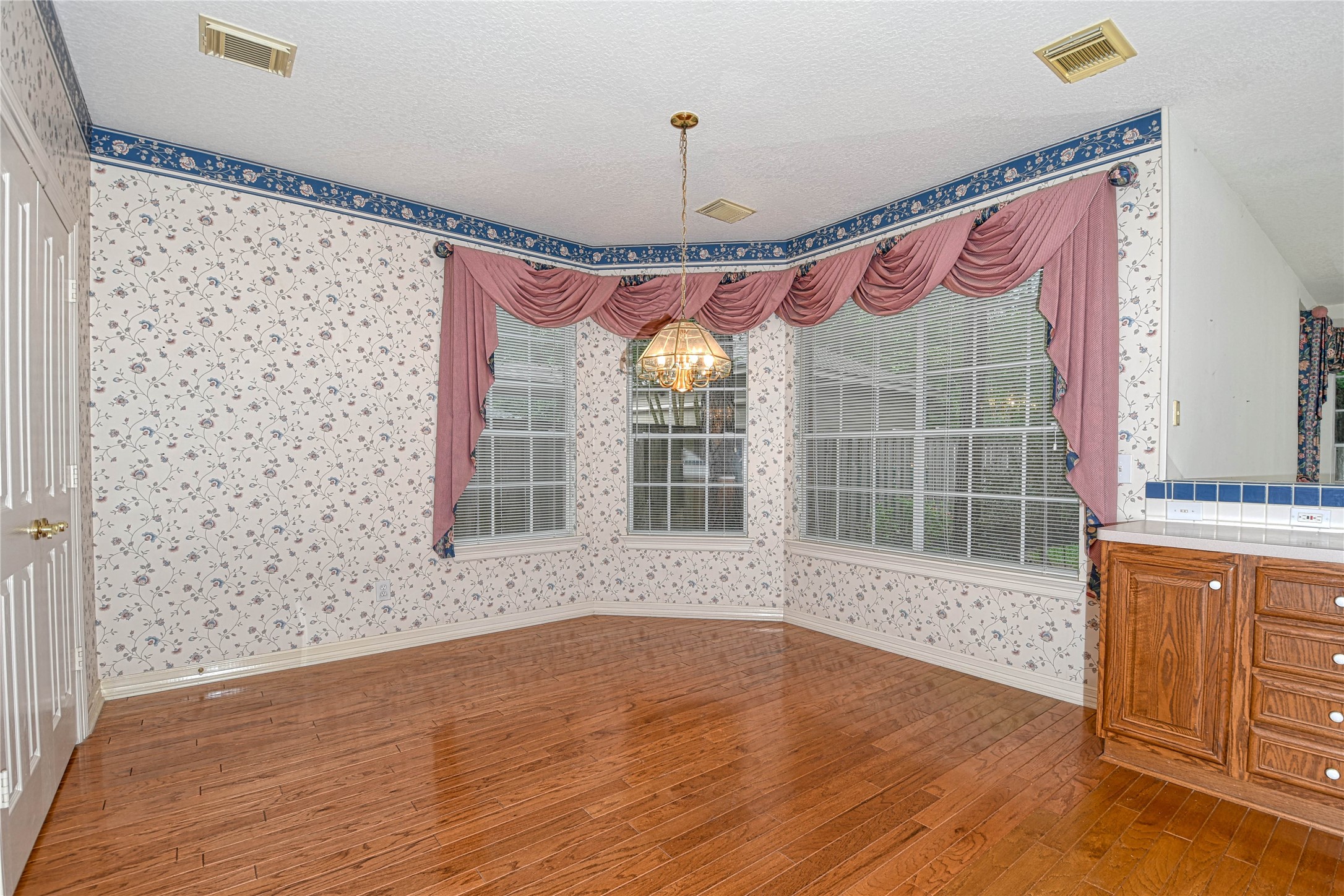 2 Woodmere Place Spring, TX 77381 - Photo 10 of 20 a view of a room with wooden floor and windows