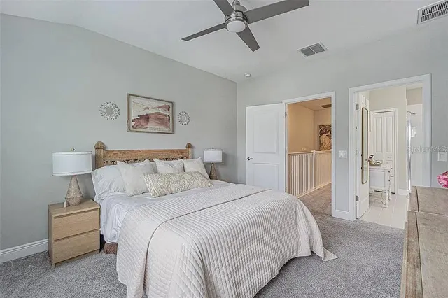 a bedroom with a bed and a painting on the wall