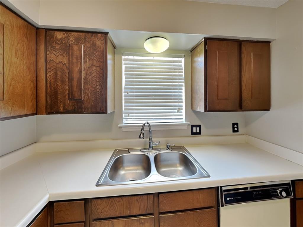 931 Roaring Springs Road Fort Worth, TX 76114 - Photo 3 of 8 a kitchen with a sink cabinets and a window