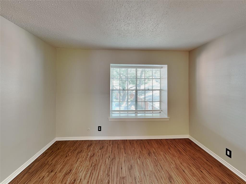 931 Roaring Springs Road Fort Worth, TX 76114 - Photo 6 of 8 an empty room with wooden floor and windows