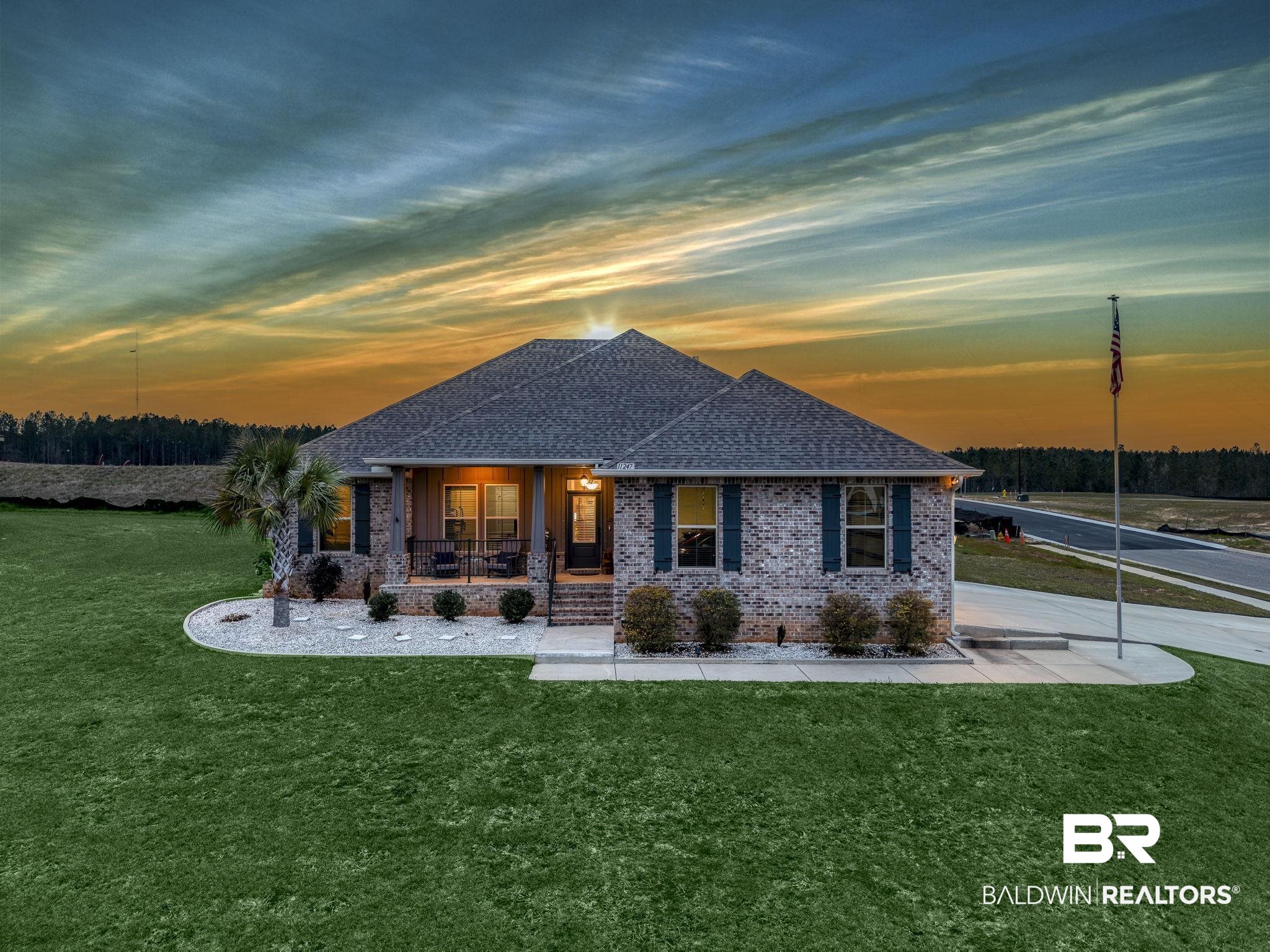 11247 Thistledown Loop Spanish Fort, AL 36527 - Photo 67 of 72 View of front of home with covered porch, brick siding, a front lawn, and roof with shingles